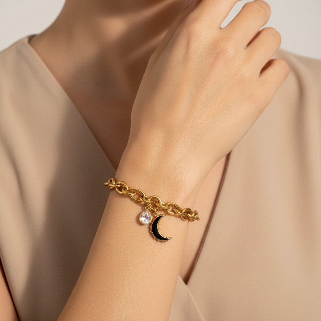 Seraphina Treasures gold chain bracelet with clear water drop charm and black moon charm.