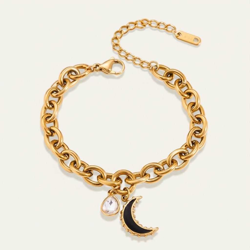 Seraphina Treasures gold chain bracelet with clear zirconia water drop and black moon charm.