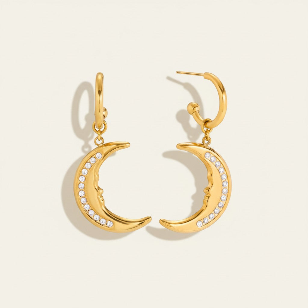 Seraphina Treasures gold crescent moon earrings with crystal accents and a subtle face detail.