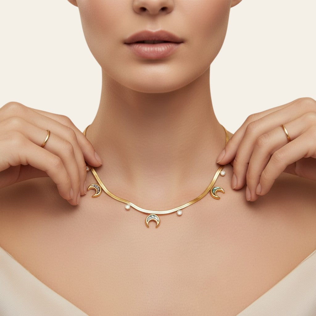 Seraphina Treasures gold serpentine chain necklace with crescent moon and round crystal pendants.