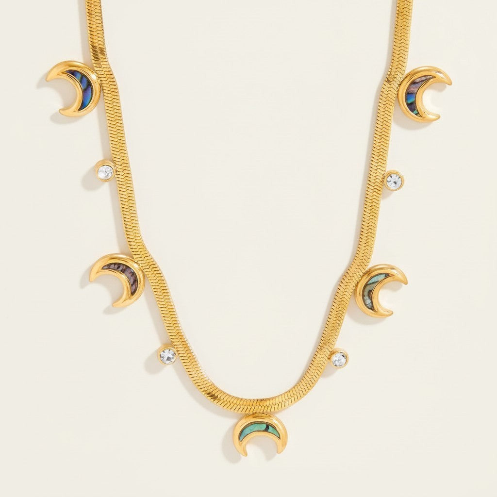 Seraphina Treasures gold serpentine chain necklace with crescent moon and crystal pendants.