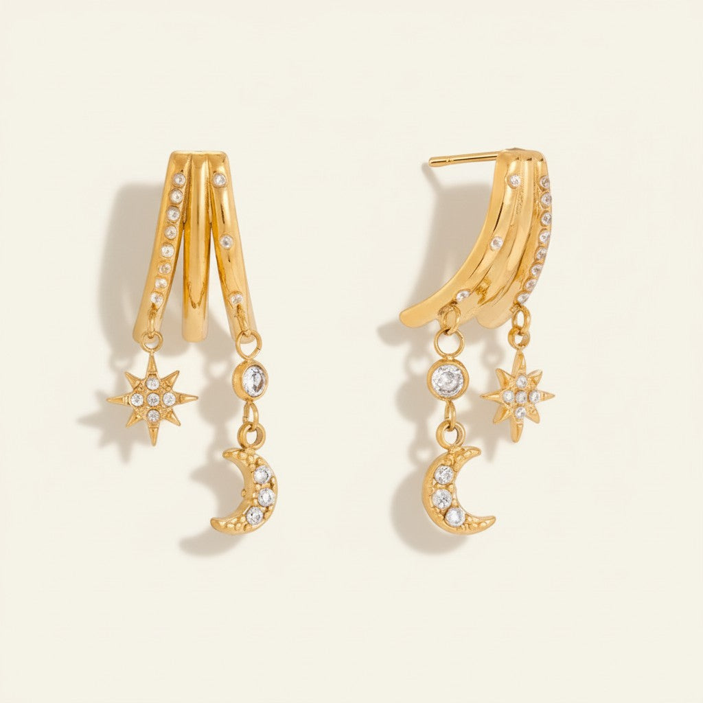 Seraphina Treasures gold-tone earrings with moon and star charms, adorned with clear zircons. Celestial design.