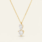 Seraphina Treasures gold necklace with stacked clear zircon stones in water drop and heart shapes.