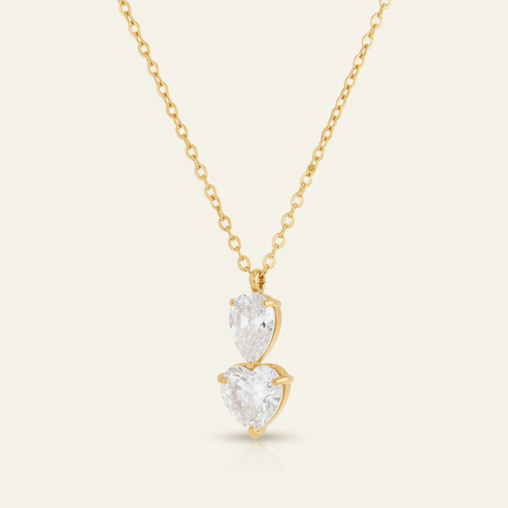 Seraphina Treasures gold necklace with stacked clear zircon stones in water drop and heart shapes.