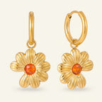 Seraphina Treasures gold flower hoop earrings with orange cubic zirconia center. Nature-inspired floral design.