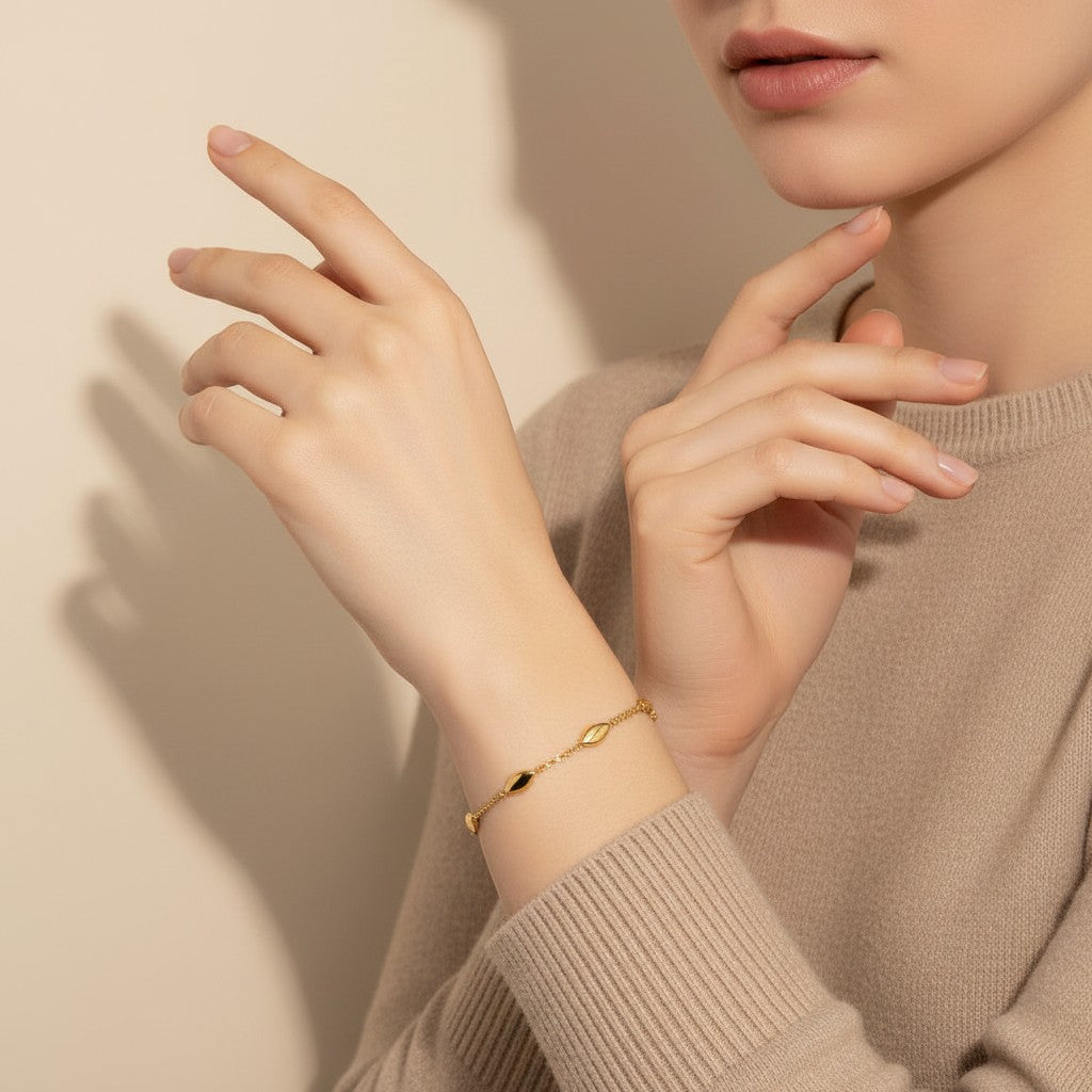 Seraphina Treasures Niobe gold-tone stainless steel bracelet with oval links and adjustable chain.