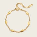 Seraphina Treasures gold-tone stainless steel Niobe bracelet with oval links and adjustable chain.