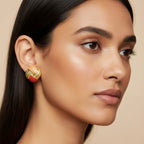 Seraphina Treasures gold earrings with peach and red enamel accents and textured detail.