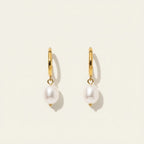 Seraphina Treasures Myrrhina gold huggie hoop earrings with freshwater pearl pendants.