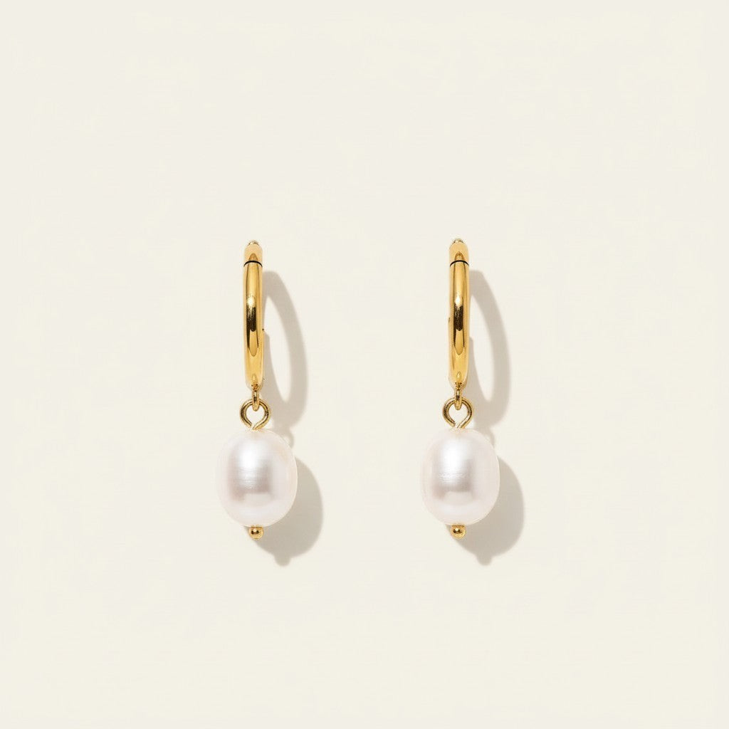 Seraphina Treasures Myrrhina gold huggie hoop earrings with freshwater pearl pendants.