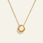 Seraphina Treasures gold necklace with a single pearl centerpiece set in an organic gold frame.