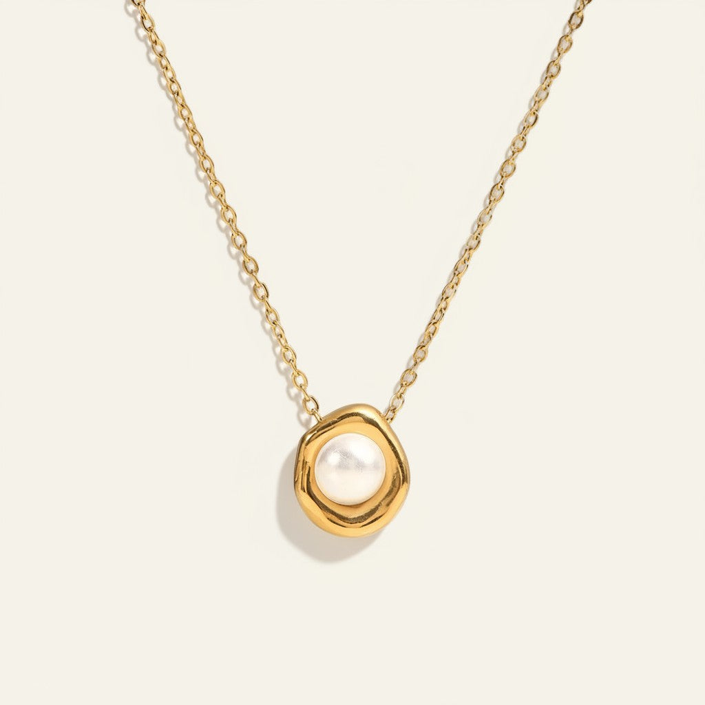 Seraphina Treasures gold necklace with a single pearl centerpiece set in an organic gold frame.