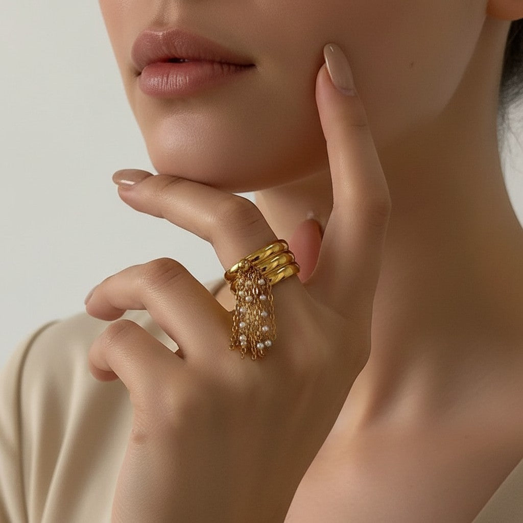 Seraphina Treasures gold-tone adjustable ring with layered bands and a delicate faux pearl tassel chain.