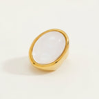 Seraphina Treasures gold ring with a large oval clear resin stone. Minimalist statement jewelry.