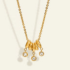 Seraphina Treasures gold necklace with five rings and three dangling rhinestones. Elegant chain necklace.