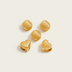 Seraphina Treasures Lyraea Earrings: gold metal, ribbed texture, heart and square shapes. Modern, lightweight earrings for everyday elegance.