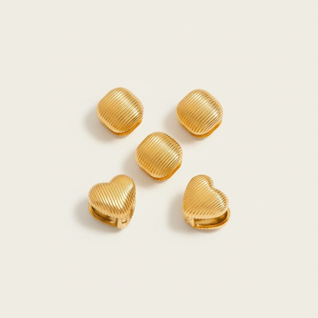 Seraphina Treasures Lyraea Earrings: gold metal, ribbed texture, heart and square shapes. Modern, lightweight earrings for everyday elegance.