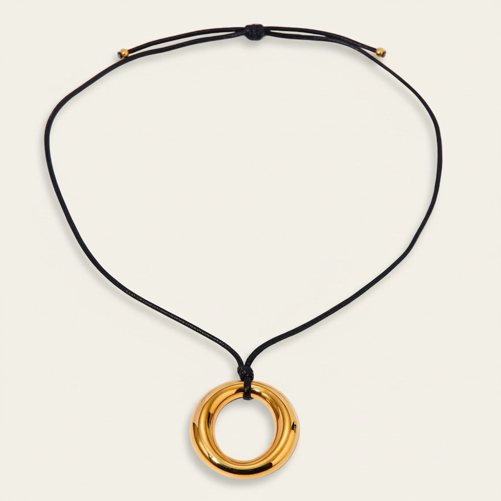 Seraphina Treasures gold-tone ring pendant necklace on black wax cord with adjustable tie closure.