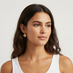 Seraphina Treasures gold seashell drop earrings worn by a woman with blonde hair, featuring a delicate shell pendant.