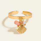 Seraphina Treasures gold ring with pink coral, pearl, and seashell charms.