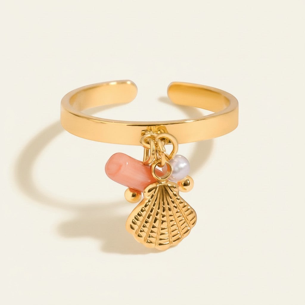 Seraphina Treasures gold ring with pink coral, pearl, and seashell charms.