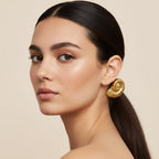 Seraphina Treasures gold fossil shell hair rope with a black elastic band.