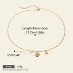 Seraphina Treasures gold necklace with shell and starfish charms, accented with white zircon. Adjustable length.