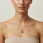 Seraphina Treasures gold necklace with a shell pendant featuring iridescent blue and green abalone.