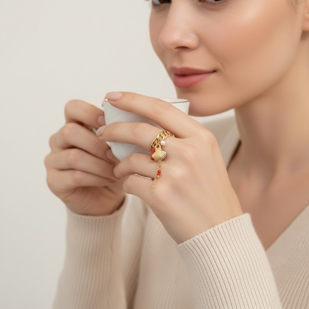 Seraphina Treasures gold ring with shell, coral, and pearl charms. Ocean-inspired design.