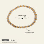 Seraphina Treasures Clio bracelet with alternating gold and silver stainless steel beads. Elastic design for a comfortable fit.