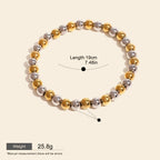 Seraphina Treasures Clio bracelet with alternating gold and silver stainless steel beads. Elastic design for comfortable fit.
