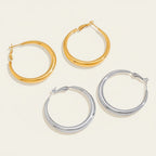 Seraphina Treasures Kyphera gold and silver polished hoop earrings. Smooth, curved silhouette.