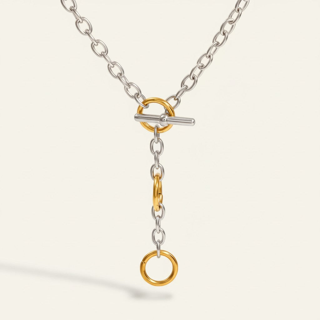 Seraphina Treasures Orphynne necklace with silver chain, gold toggle clasp, and dangling gold rings.