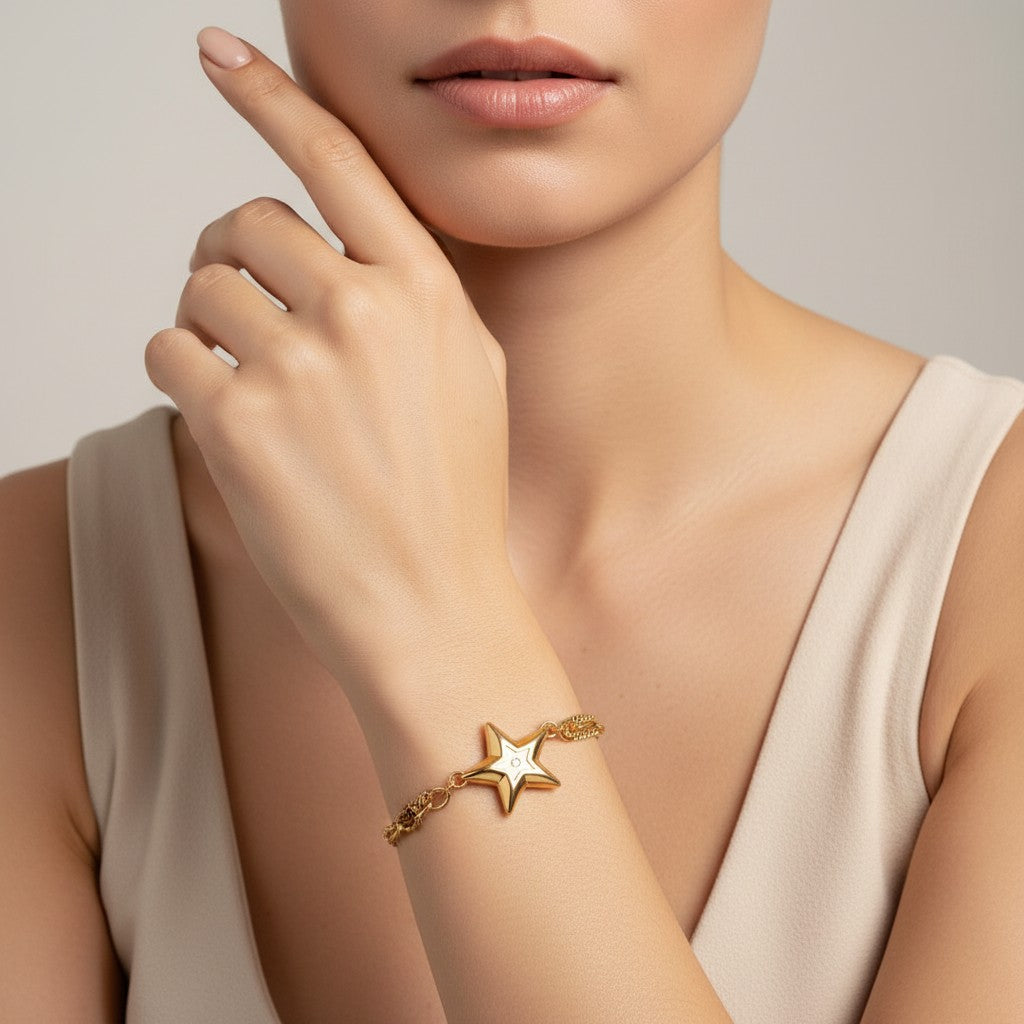 Seraphina Treasures gold-tone bracelet with a star charm featuring a white zircon stone. Adjustable chain.