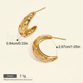 Seraphina Treasures gold hoop earrings with cut-out star and moon designs, accented with cubic zirconia stones.
