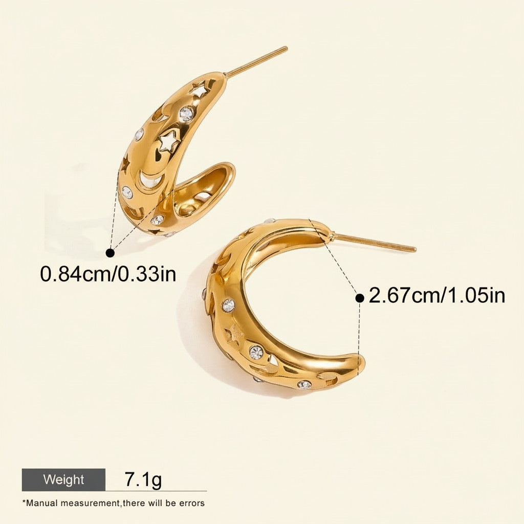 Seraphina Treasures gold hoop earrings with cut-out star and moon designs, accented with cubic zirconia stones.