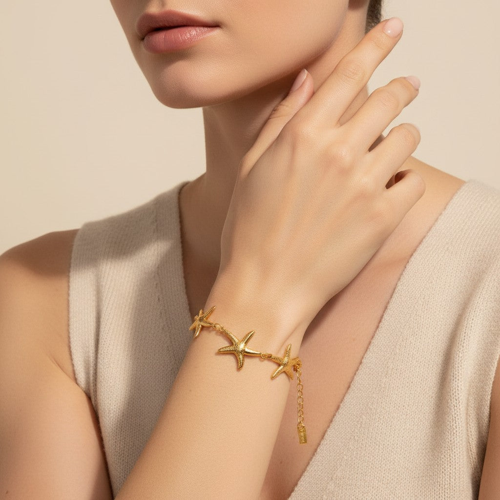 Seraphina Treasures gold-tone bracelet with multiple starfish charms, delicate chain, and adjustable clasp.