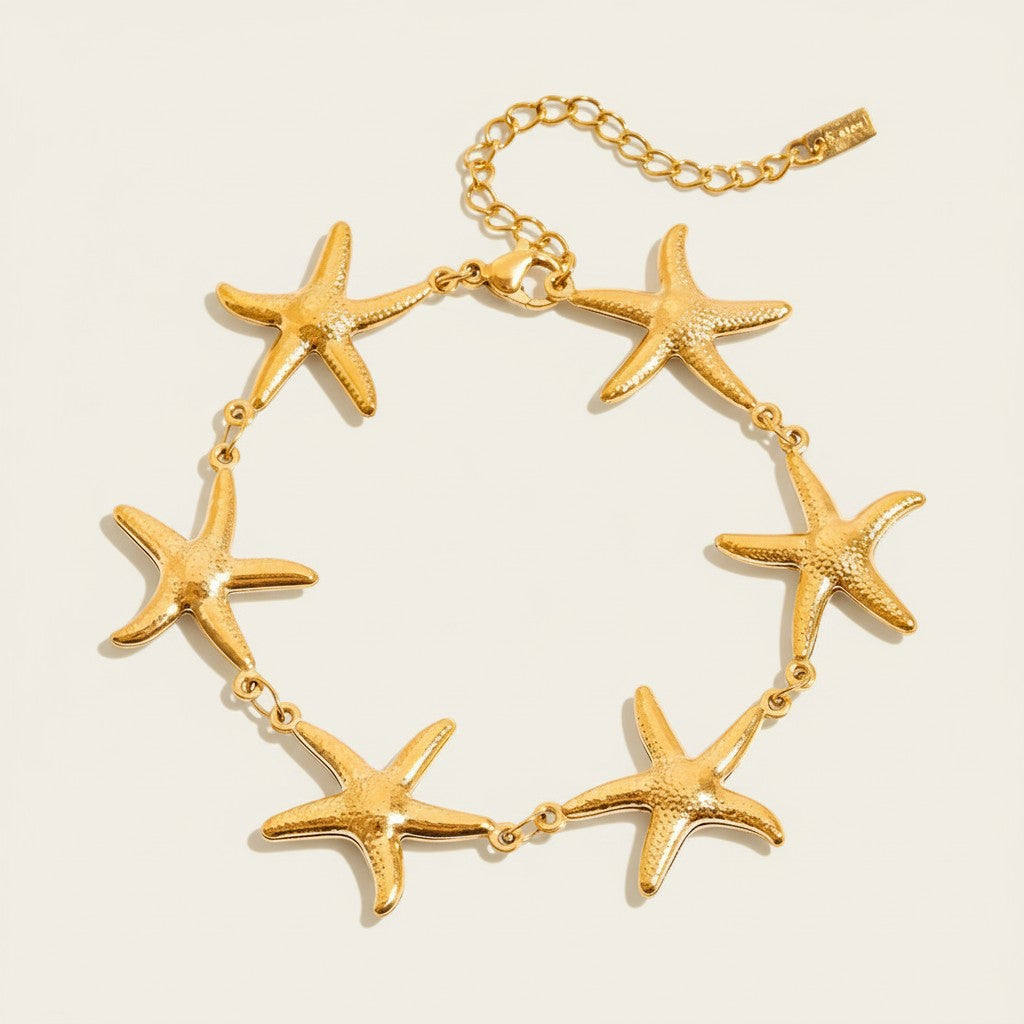 Seraphina Treasures gold-tone bracelet with multiple starfish charms, perfect for beachwear.