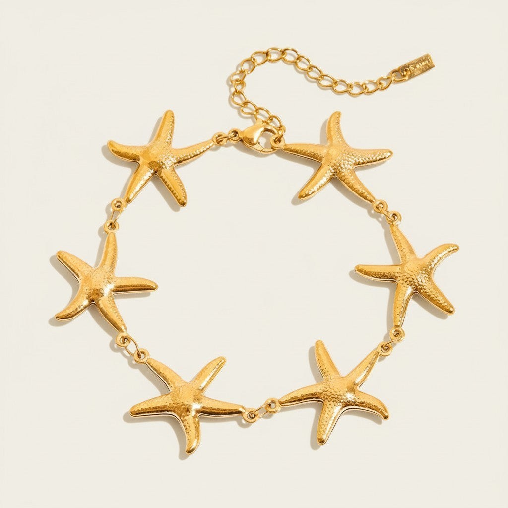 Seraphina Treasures gold-tone bracelet with multiple starfish charms, perfect for beachwear.
