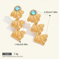 Seraphina Treasures gold starfish dangle earrings with blue gemstone accents. Lightweight and hypoallergenic.