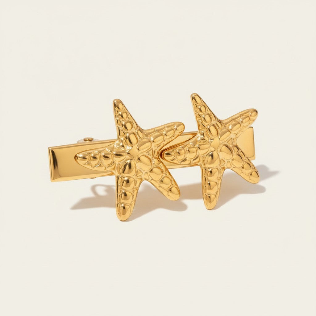 Seraphina Treasures gold-tone hair clip with two textured starfish designs, perfect for beach-inspired style.