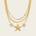 Seraphina Treasures gold necklaces with hammered starfish pendants and delicate chains. Coastal elegance.