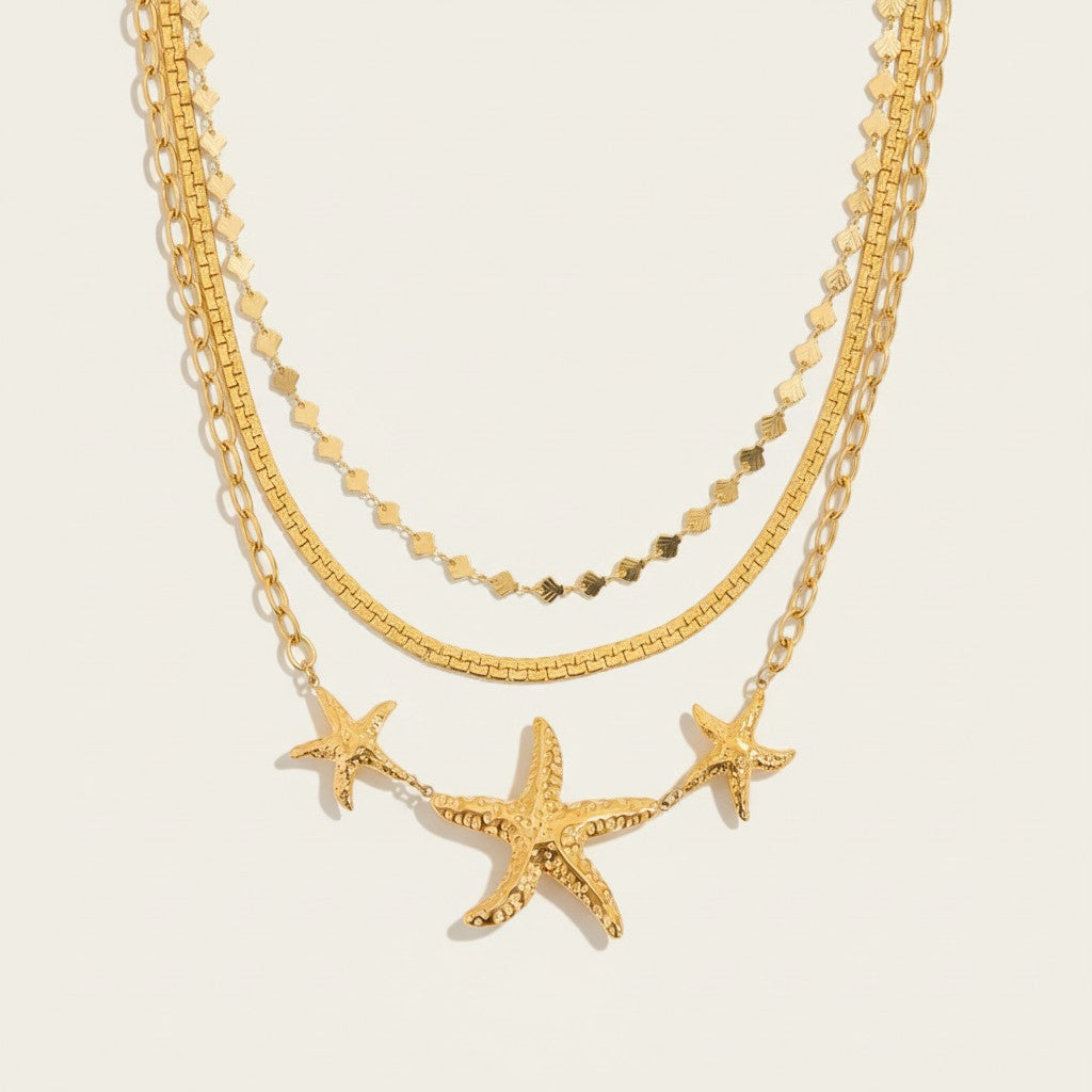 Seraphina Treasures gold necklaces with hammered starfish pendants and delicate chains. Coastal elegance.