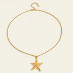 Seraphina Treasures gold starfish pendant necklace with rope chain. Features a textured starfish with a central swirl.