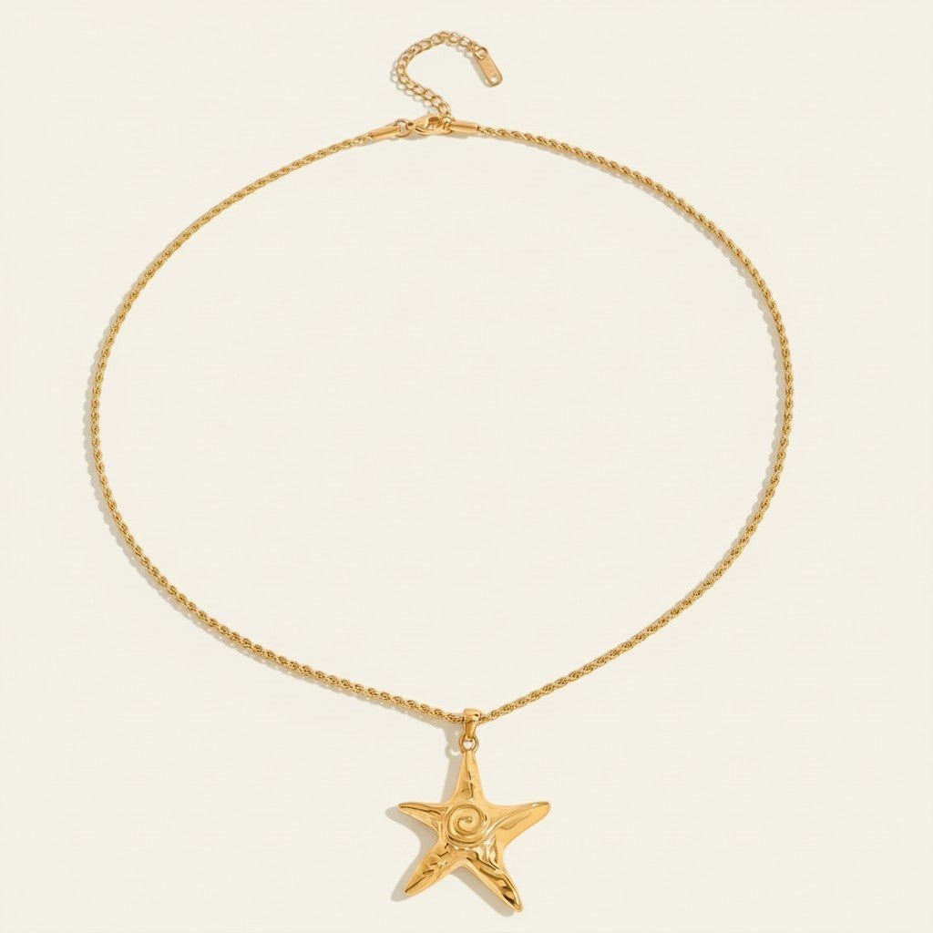 Seraphina Treasures gold starfish pendant necklace with rope chain. Features a textured starfish with a central swirl.