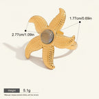 Seraphina Treasures gold starfish ring with a grey natural stone center, textured details, and hypoallergenic properties.