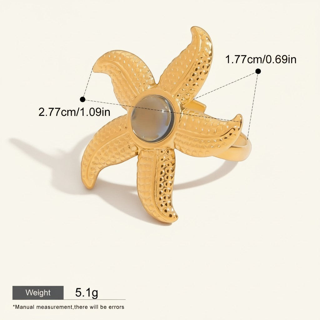 Seraphina Treasures gold starfish ring with a grey natural stone center, textured details, and hypoallergenic properties.