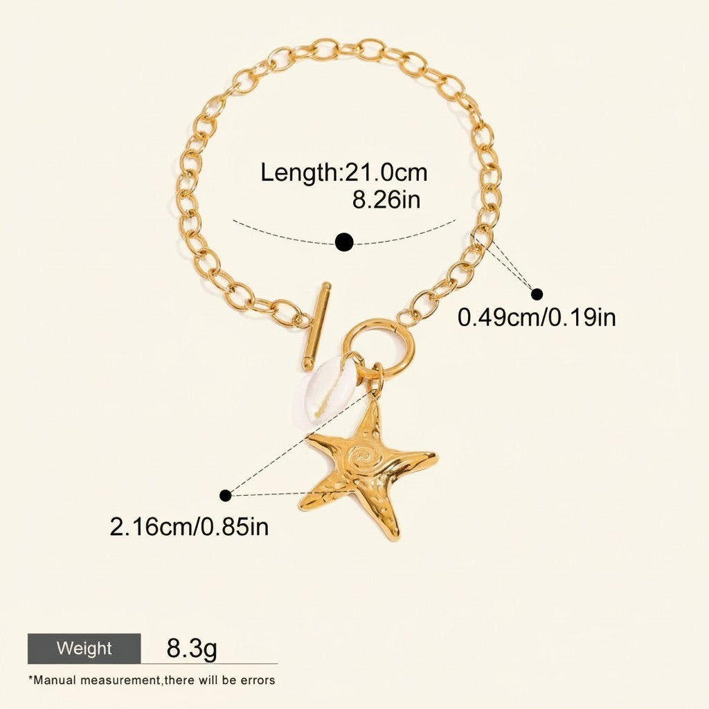 Seraphina Treasures gold-tone metal bracelet with toggle clasp, featuring a starfish charm and a small white shell charm.