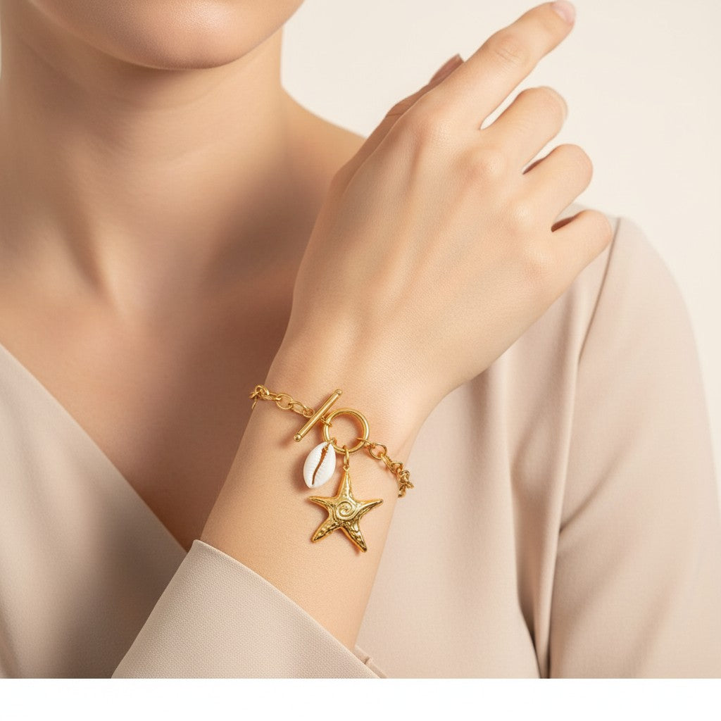 Seraphina Treasures gold chain bracelet with starfish and shell charms, toggle clasp, 21cm length.