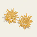 Seraphina Treasures gold sun and moon stud earrings with crystal accents.